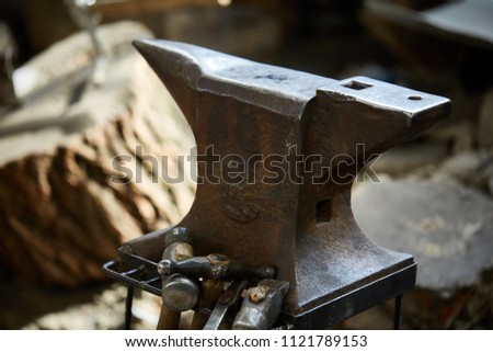 Big heavy anvil in the blacksmith's workshop, close-up, selective focus.