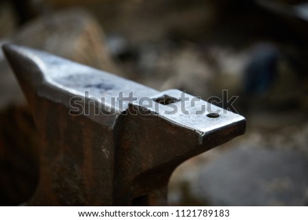 Big heavy anvil in the blacksmith's workshop, close-up, selective focus.