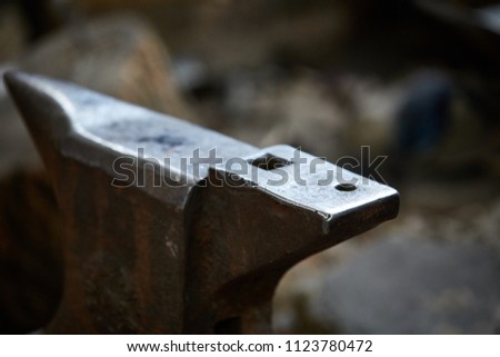 Big heavy anvil in the blacksmith's workshop, close-up, selective focus.