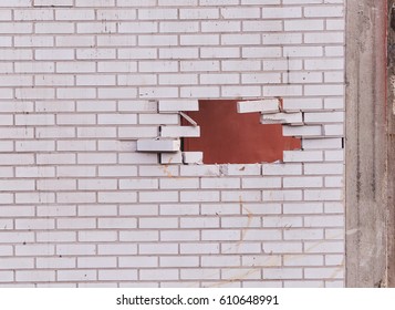 Big Hole In White Brick Wall At Demolition Site.