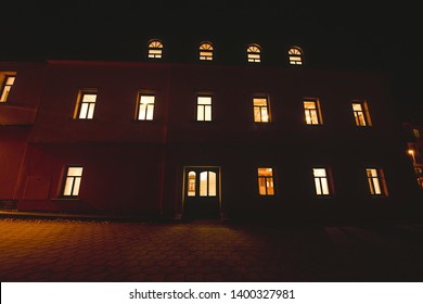 Big House At Night With Glowing Windows