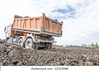 Big Hydraulic Dump Truck Is Moving Into Reverse, Prepare To Unload Cargo.