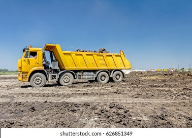 Big Hydraulic Dump Truck Is Moving Into Reverse, Prepare To Unload Cargo.