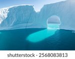 Big icebergs in Atlantic ocean, Ilulissat icefjord, western Greenland. Blue sea and the blue sky at sunrise.
Melting icebergs by the coast of Greenland, on a beautiful summer day. Global warming