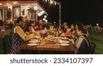 Big Indian Family Garden Party Celebration, Gathered Together at the Table in Backyard. Relatives and Friends, Young and Elderly are Eating, Drinking, Passing Dishes and Having Fun