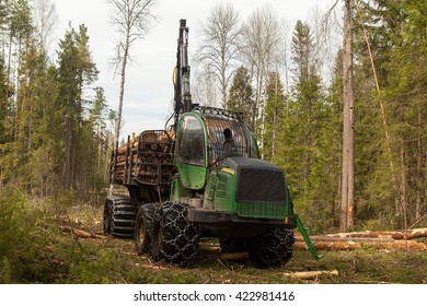 Big Industrial Wood Harvester In Pine Forest With Logs