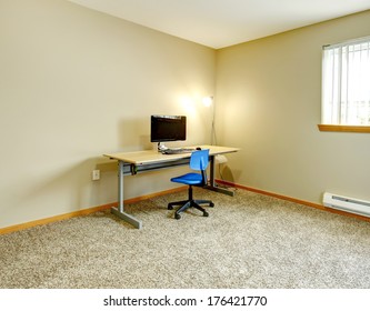 Big Ivory Office Room With Window And Beige Carpet Floor. Furnished With Small Desk And Computer