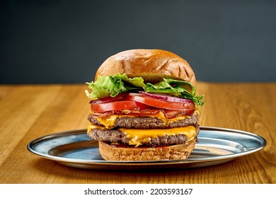 A Big Juicy Burger With Tomatoes, Onions, Cheese And C. Close-up, Selective Focus