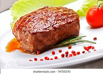 Big Juicy Grilled Steak With Greens On The Plate