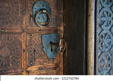 Big key in rustic door of wooden church