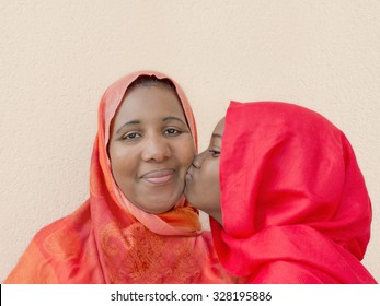 A big kiss on mummy's cheek