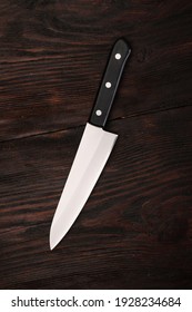 Big Kitchen Knife Macro On Brown Wood Texture Background