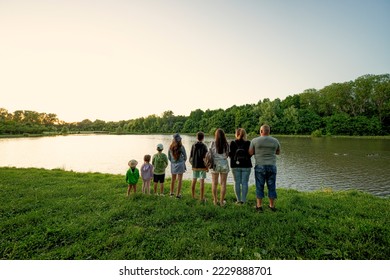 Big and large family against lake in sunrise. Six children. Parents and kids. - Powered by Shutterstock