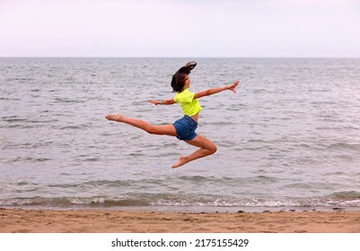Big Leap Of The Deer Called BICHE Performed To Perfection By The Athletic Girl By The Sea In Summer