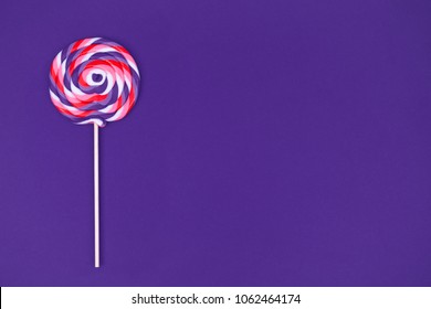 Big Lollipop On Solid Ultra Violet Background. Horizontal