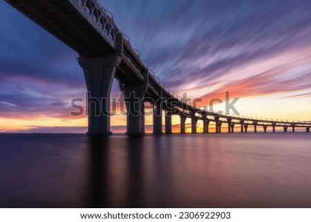 Big long bridge over the bay at sunset