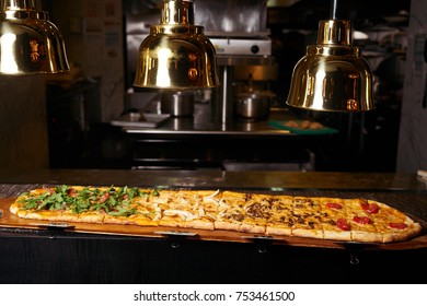 Big Long Mix Pizza With Cheese On Wooden Pizza Board, In Pizza Man Hands