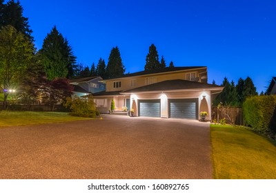 Big Luxury House With Two Double Doors Garages And Wide Driveway At Night, Dusk Time In Suburbs Of Vancouver, Canada.