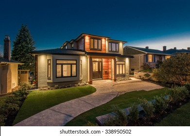 Big luxury, modern house at dusk, night time in suburbs of Vancouver, Canada.