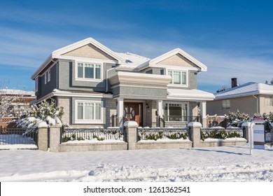 Big luxury residential house in winter season. North American family house on winter sunny day