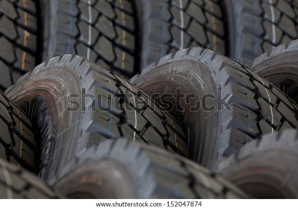 Big\
machines tires stack background. Industrial\
tires
