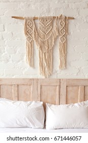 Big Macrame On A White Brick Wall In Bedroom