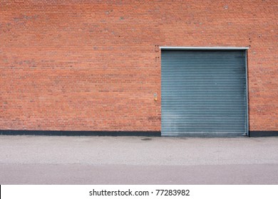 Big Metal Garage Door On Big Brick Wall.