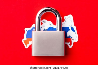 Big metal lock on flag of Russia. Concept of sanctions on Russia because of aggression against Ukraine - Shutterstock ID 2131784205