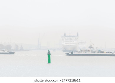 Big modern ferry ship navigate from Rostock harbor Warnemunde bay foggy spring autumn morning misty weather scenic view background. Maritime traffic liner passenger cargo vessel at Baltic sea Germany. - Powered by Shutterstock