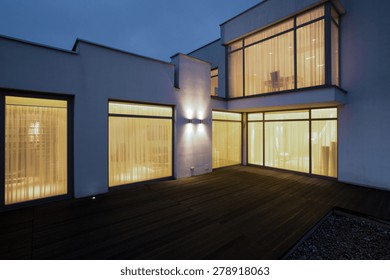 Big Modern House With Wooden Porch At Night