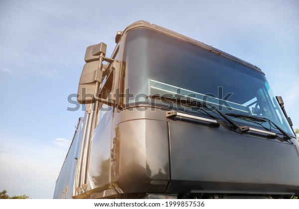 Big modern truck against\
blue sky