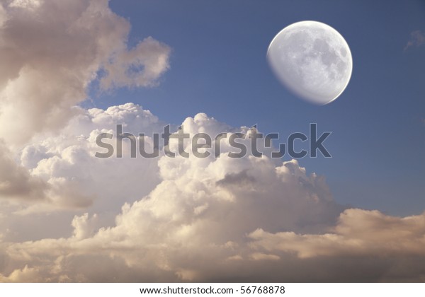 big moon in the\
daytime sky with clouds