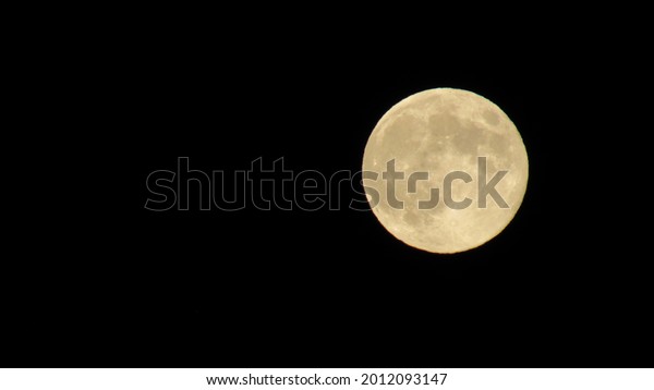 big moon in the night sky. Super\
full moon with dark background. Horizontal\
Photography.