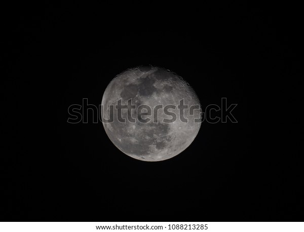 The big moon and\
texture in a black sky