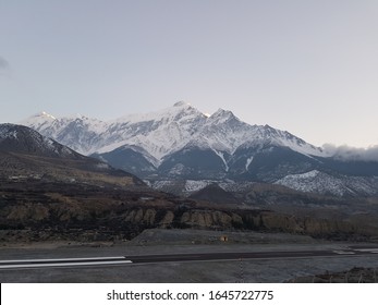 Big mountains are covered with snow behind of jomsom airport runway - Shutterstock ID 1645722775