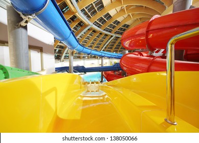 Big Multi-colored Indoor Water Slides In Aquapark. Descent Yellow Slide.