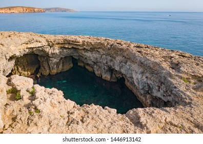 Big Natural Hole In The Rock. Coral Lagoon In Mellieha. Malta Island