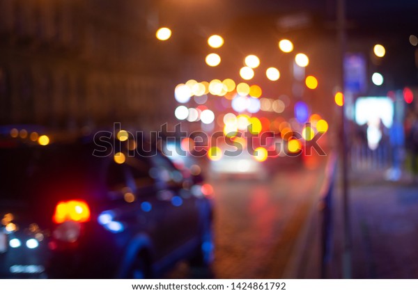 Big night city street with cars.
Blur street with colorful light bokeh. Abstract
background.