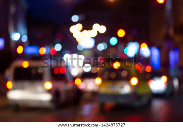 Big\
night city street with cars. Blurred street with colorful light\
bokeh. Cars in the traffic jam. Abstract\
background.