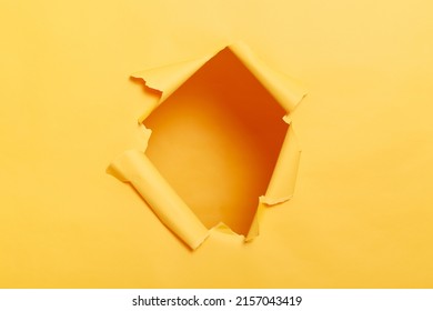 Big paper hole in center of yellow background, blank space to insert your advertising content promotion or text information, torn ripped wall. - Shutterstock ID 2157043419