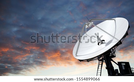 Big parabolic antenna against dramatic sky
