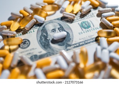 Big Pharma Conspiracy Theory. Medical Pills Lying On Top Of US Dollar Bill.