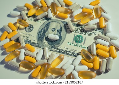 Big Pharma Conspiracy Theory. Medical Pills Lying On Top Of US Dollar Bill.