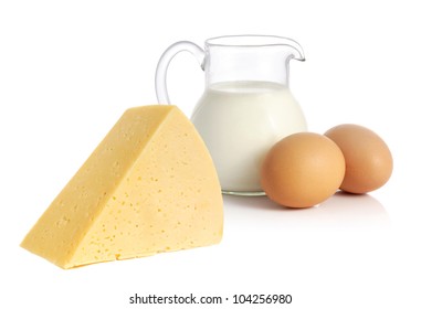 Big Piece Of Cheese, Glass Jug With Milk And Two Eggs On White Background