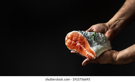 The big piece salmon is in the hands of the chef cook. prepared for cooking. chef marinating salmon fish, adds herbs, seasoning to fish. - Powered by Shutterstock