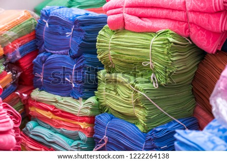 Big pile of colorful towels at production place
