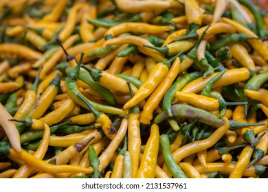 Big Pile Of Yellow Chili Peppers, Also Known As Pepperoni At Street Market, Freshly Harvested. Natural Background.