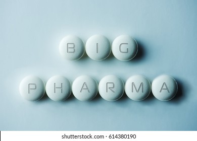 Big Pharma.?Tablets Or Pills, Laid On White Background With The Letters BIG PHARMA. Intentionally Shot In Low Key And Surreal Bluish Tone.  