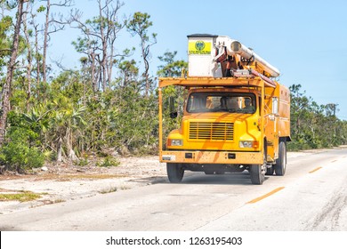 Big Pine Key, USA - May 1, 2018: A Cut Above FL Keys Tree Professional Service Truck With Bucket, Workers Driving On Road In Florida, Providing Trees Cutting, Trimming, Removal Services