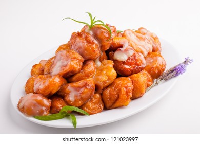 A big plate of freshly made saucy and golden pumpkin fritters. - Shutterstock ID 121023997
